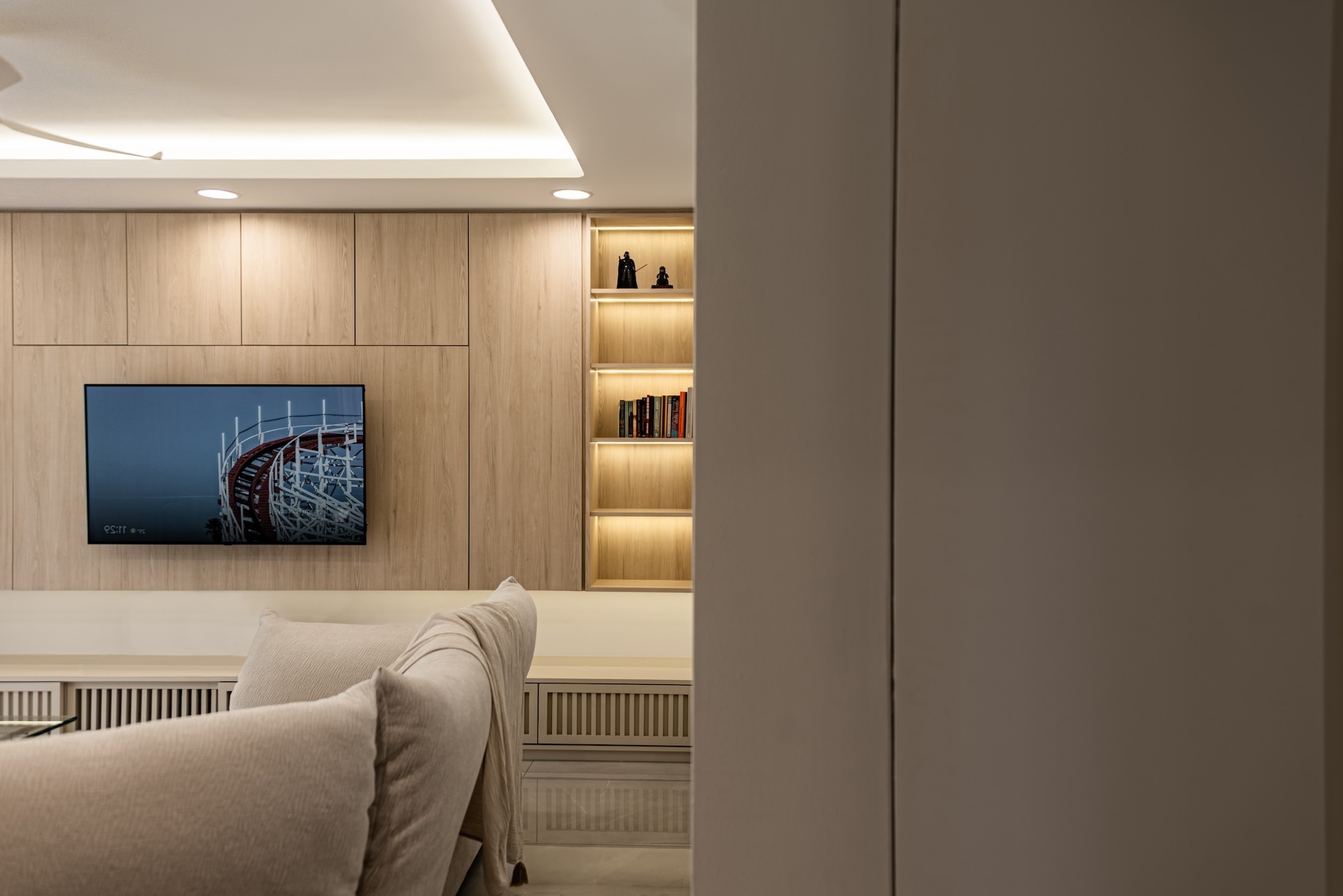 Mont Kiara Astana minimalist living room with custom wooden TV console and backlit shelves for interior design project by Sharmin Leong